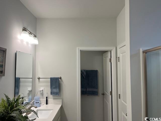 bathroom featuring vanity and an enclosed shower