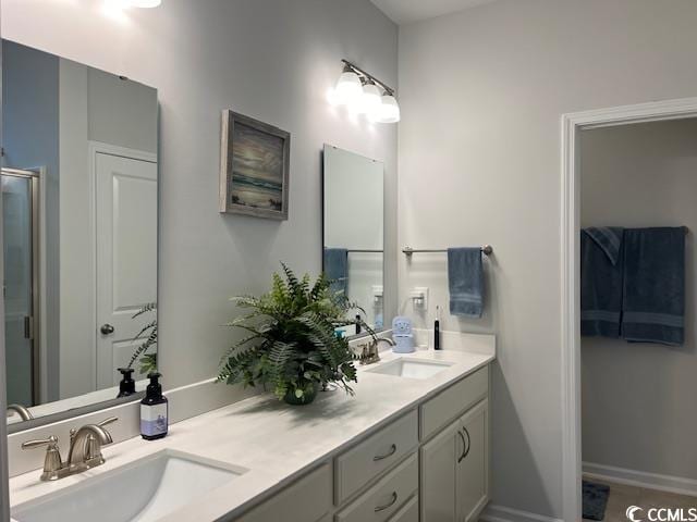 bathroom featuring tile patterned flooring, vanity, and an enclosed shower