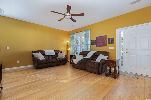 living room featuring ceiling fan and light wood-type flooring