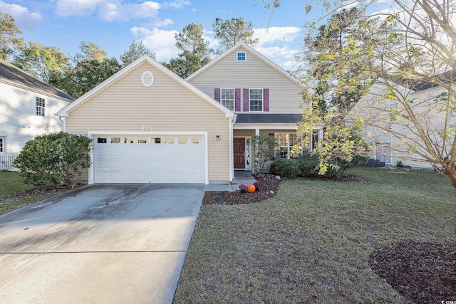 view of property with a garage and a front lawn