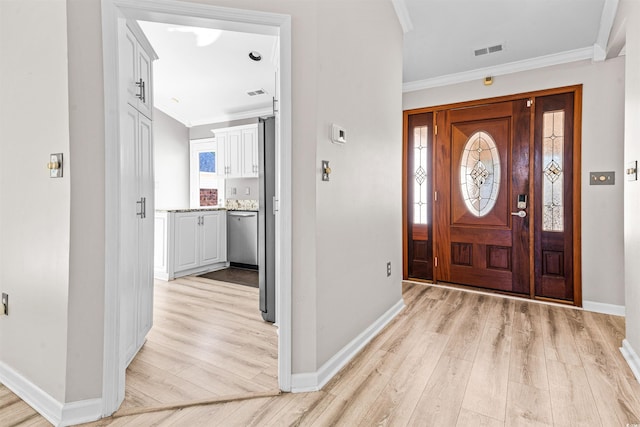 entryway featuring light wood-type flooring and crown molding