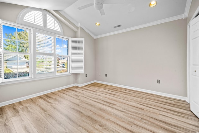 spare room featuring ceiling fan, light wood-type flooring, crown molding, and vaulted ceiling