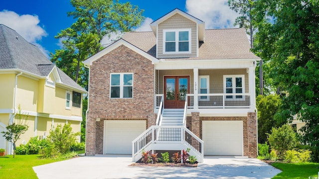 1010 Club House Dr, North Myrtle Beach, SC 29582 - view of front of property featuring brick siding, stairs, a garage, french doors, and concrete driveway