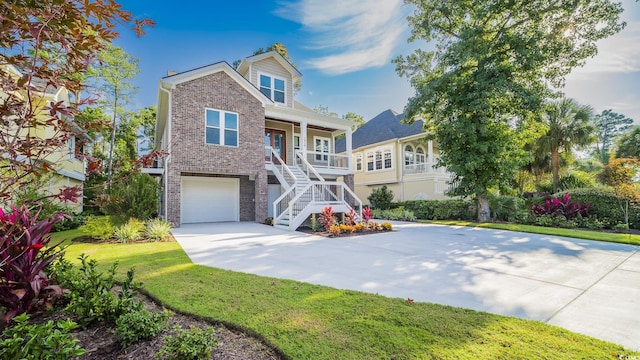 1010 Club House Dr, North Myrtle Beach, SC 29582 - view of front facade with stairs, covered porch, concrete driveway, an attached garage, and brick siding