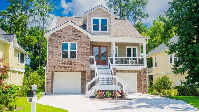 1010 Club House Dr, North Myrtle Beach, SC 29582 - view of front of home featuring stairway, brick siding, french doors, driveway, and a garage