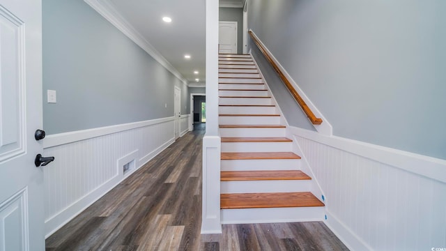 stairs featuring ornamental molding and hardwood / wood-style flooring