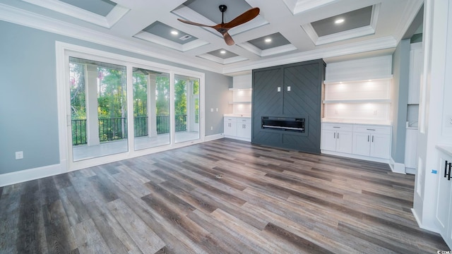 unfurnished living room featuring dark hardwood / wood-style floors, ceiling fan, and crown molding