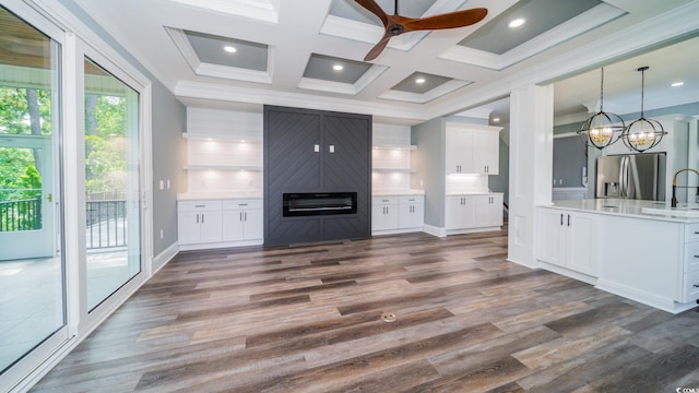 1010 Club House Dr, North Myrtle Beach, SC 29582 - unfurnished living room featuring crown molding, a ceiling fan, a fireplace, dark wood-style flooring, and a chandelier