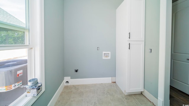 washroom with hookup for a washing machine, cabinets, and hookup for an electric dryer