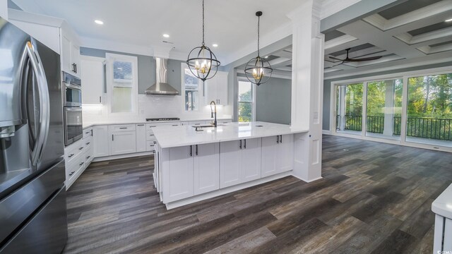 1010 Club House Dr, North Myrtle Beach, SC 29582 - kitchen featuring appliances with stainless steel finishes, wall chimney range hood, a sink, light countertops, and recessed lighting