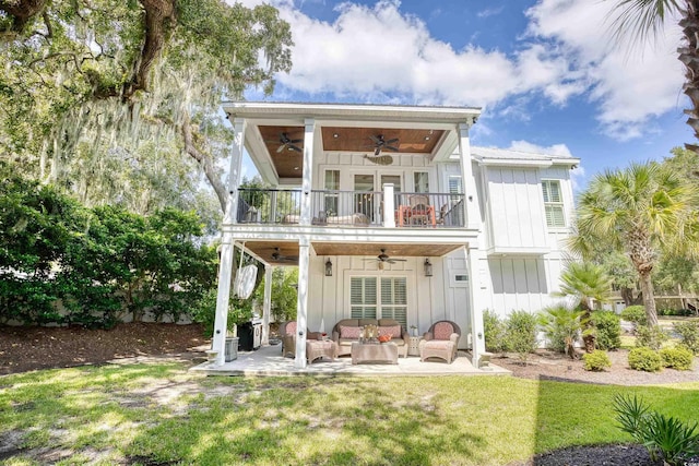 back of house featuring ceiling fan, an outdoor living space, a balcony, and a patio