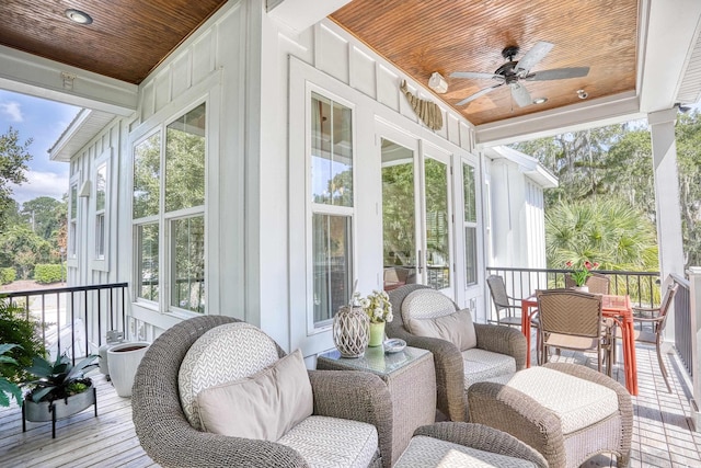 sunroom / solarium with ceiling fan, wooden ceiling, and a healthy amount of sunlight