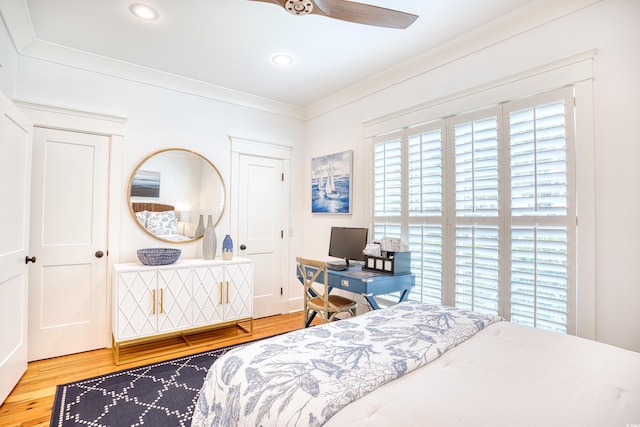 bedroom with hardwood / wood-style floors and ornamental molding