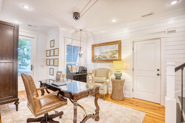 home office featuring an inviting chandelier, ornamental molding, and light wood-type flooring