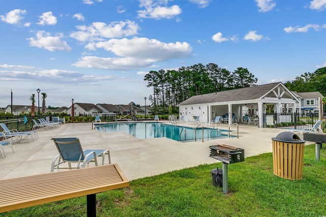 view of pool with a yard and a patio