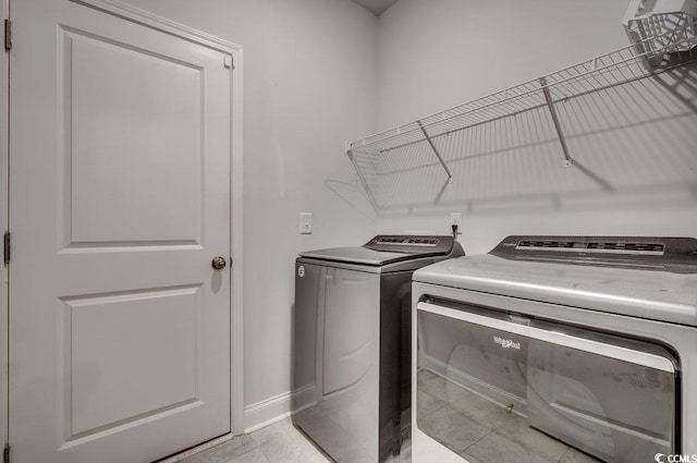 washroom featuring separate washer and dryer and light tile patterned floors