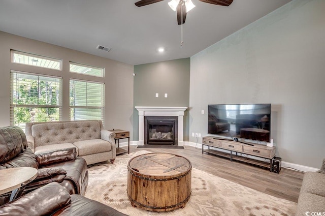 living room featuring ceiling fan and light hardwood / wood-style flooring