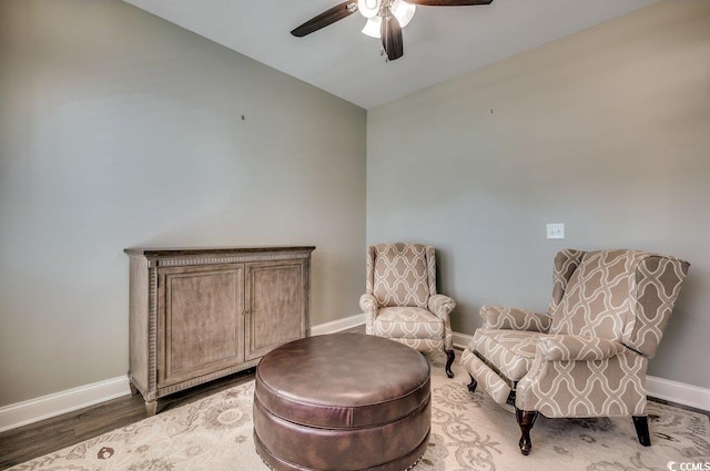 living area featuring dark hardwood / wood-style floors, vaulted ceiling, and ceiling fan