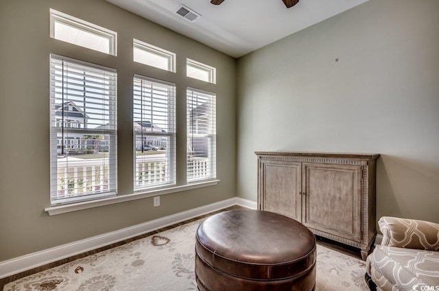 sitting room featuring ceiling fan and a wealth of natural light