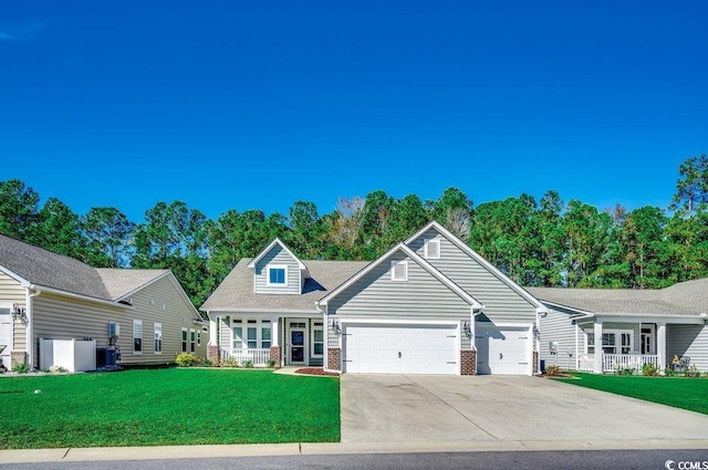 view of front of house with a front yard, central AC, and a garage