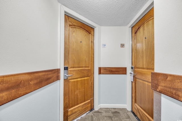 entryway with a textured ceiling