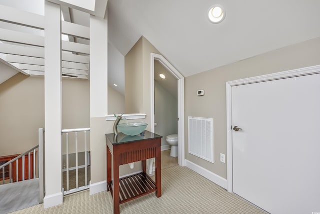 corridor featuring baseboards, visible vents, light colored carpet, an upstairs landing, and a sink