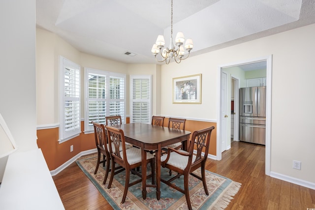 dining room with an inviting chandelier, baseboards, visible vents, and dark wood-type flooring