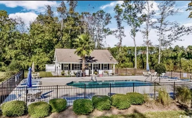 community pool featuring a patio and fence