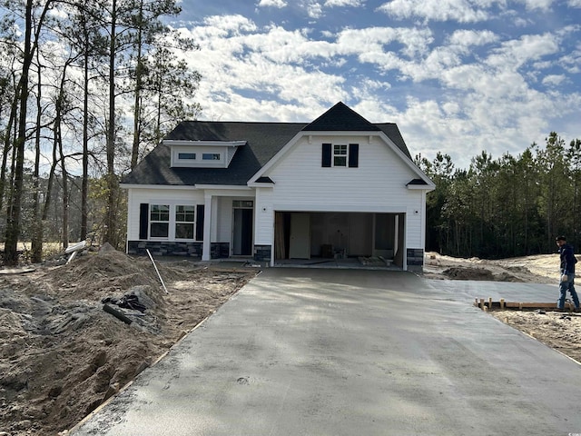 view of front facade with stone siding and driveway