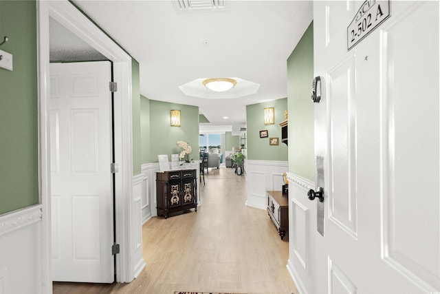 2151 Bridge View Ct Unit 2502, North Myrtle Beach, SC 29582 - hall with wainscoting, a decorative wall, and light wood finished floors