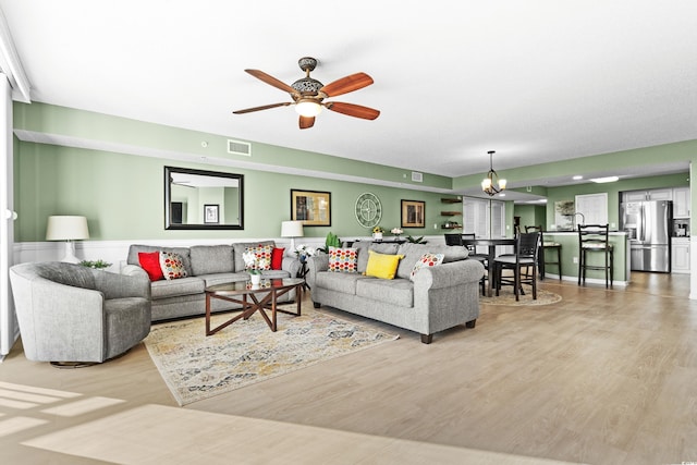 2151 Bridge View Ct Unit 2502, North Myrtle Beach, SC 29582 - living room with light wood-type flooring, a ceiling fan, and a chandelier
