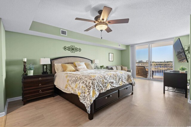 2151 Bridge View Ct Unit 2502, North Myrtle Beach, SC 29582 - bedroom with wood finished floors, access to exterior, a textured ceiling, a ceiling fan, and baseboards