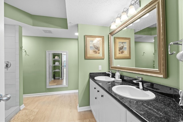 2151 Bridge View Ct Unit 2502, North Myrtle Beach, SC 29582 - bathroom featuring double vanity, wood finished floors, and baseboards