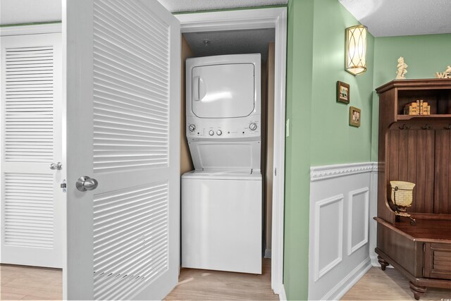 2151 Bridge View Ct Unit 2502, North Myrtle Beach, SC 29582 - washroom with stacked washer / dryer and light wood-style floors