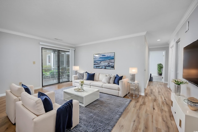 living room featuring ornamental molding and light hardwood / wood-style flooring