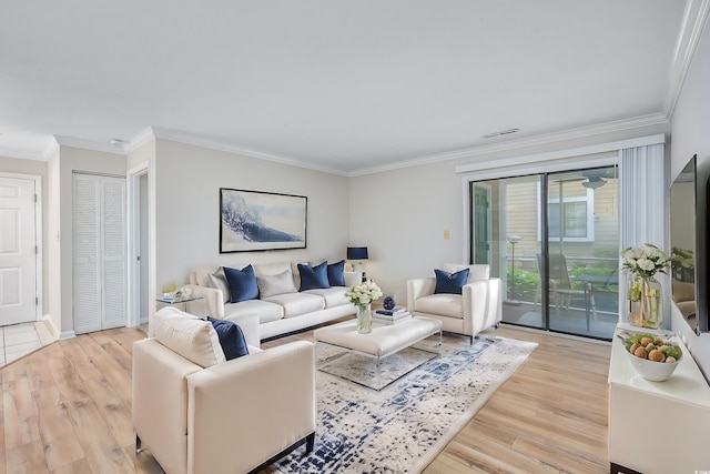 living room with light wood-type flooring and ornamental molding