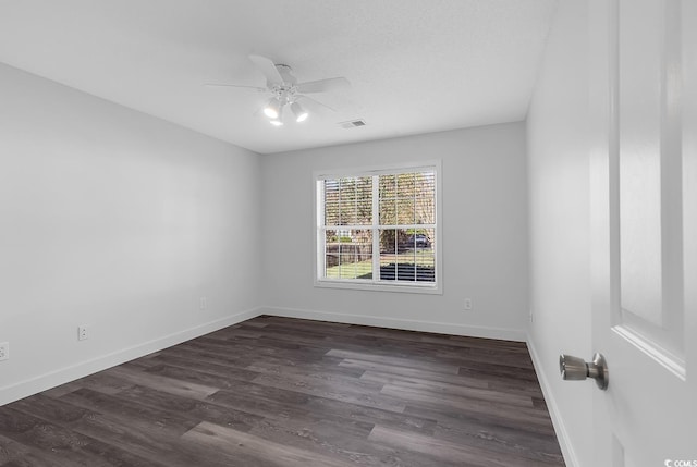 unfurnished room featuring ceiling fan and dark hardwood / wood-style flooring