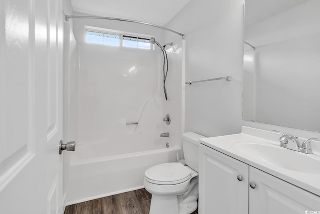 full bathroom with washtub / shower combination, hardwood / wood-style floors, vanity, and toilet