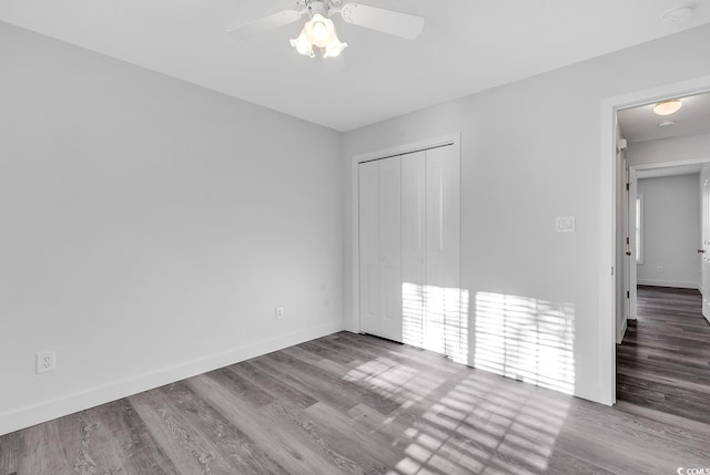 unfurnished room featuring hardwood / wood-style floors and ceiling fan