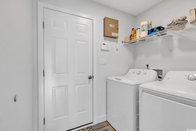 laundry area with independent washer and dryer and hardwood / wood-style flooring