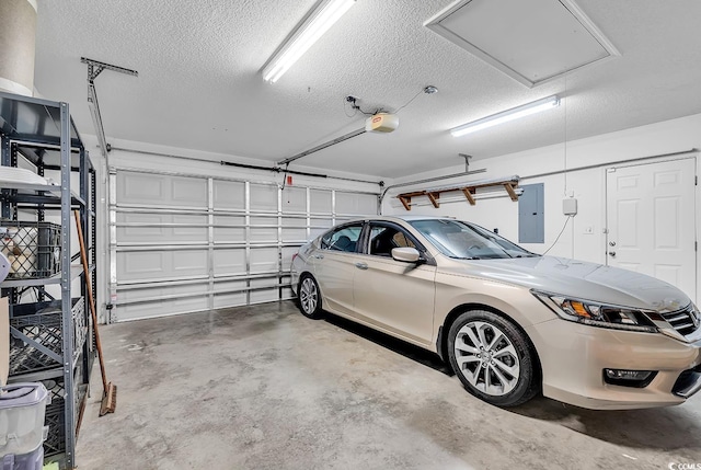 garage with a garage door opener and electric panel