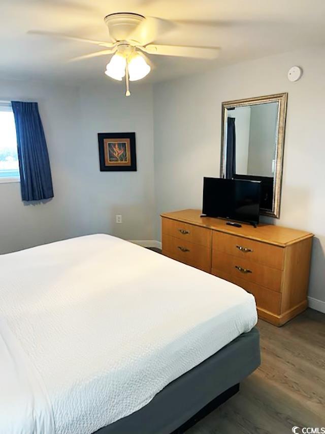 2201 S Ocean Blvd Unit 1404, Myrtle Beach, SC 29577 - bedroom featuring light wood-style floors, baseboards, and a ceiling fan