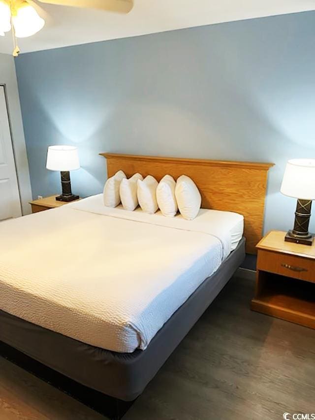 bedroom featuring dark hardwood / wood-style flooring and ceiling fan