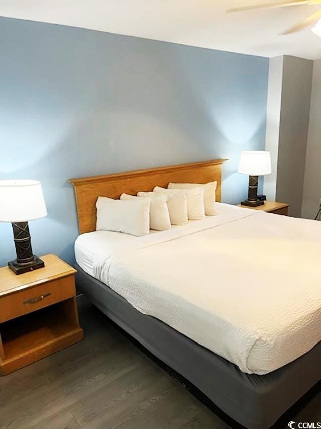 bedroom with ceiling fan and dark wood-type flooring