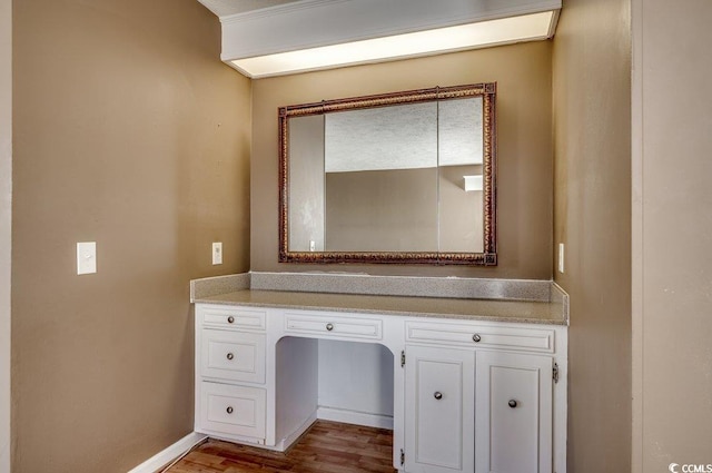 bathroom with hardwood / wood-style floors and vanity