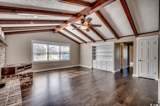 unfurnished living room featuring dark wood-type flooring, a brick fireplace, vaulted ceiling with beams, ceiling fan, and a textured ceiling