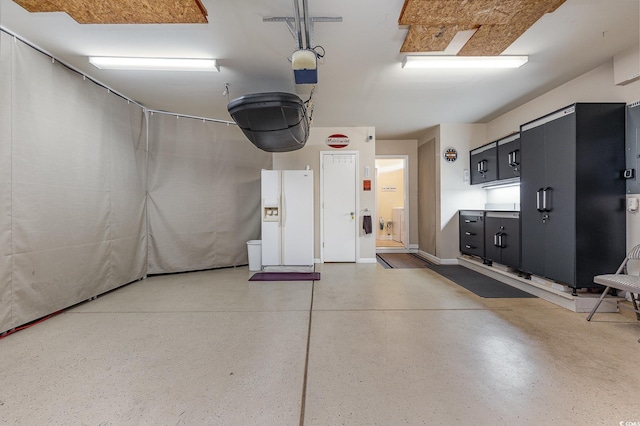 garage featuring white refrigerator with ice dispenser