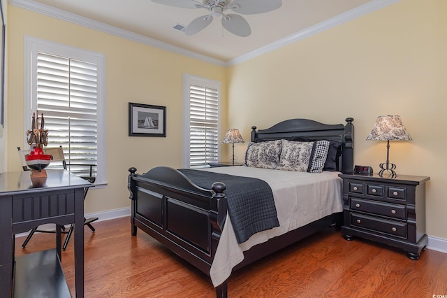 bedroom featuring hardwood / wood-style flooring, ceiling fan, and crown molding