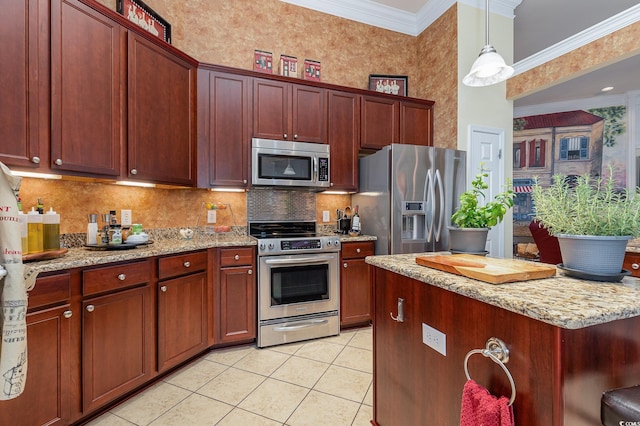 kitchen featuring light stone countertops, stainless steel appliances, crown molding, decorative light fixtures, and light tile patterned floors