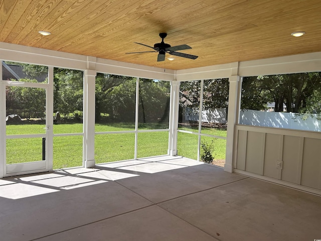 unfurnished sunroom featuring ceiling fan